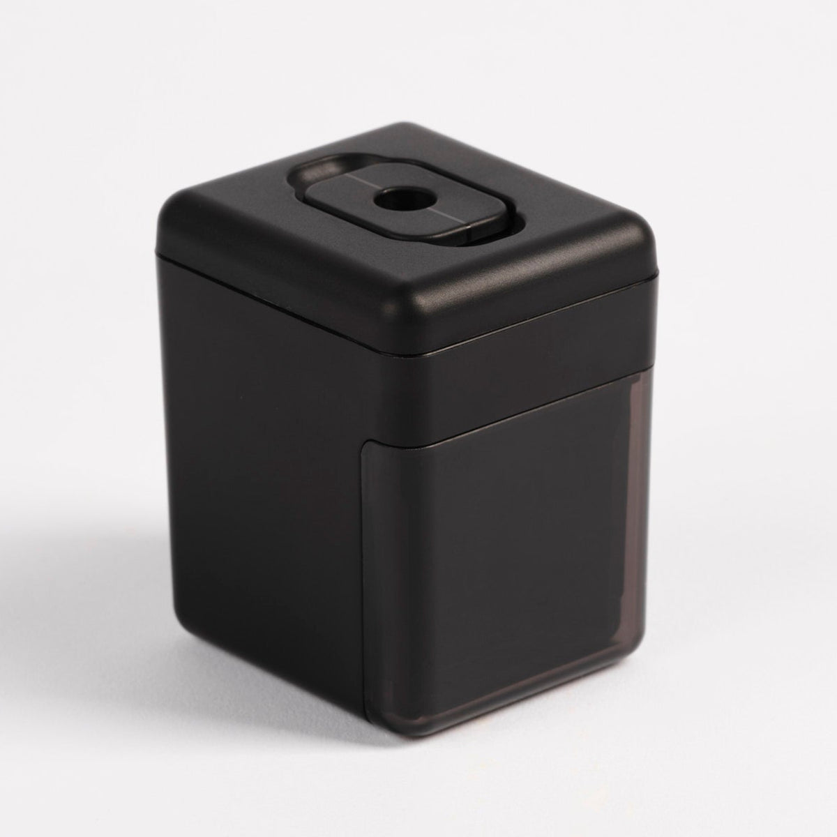 Pendulum PMU pencil sharpener in sleek black with a dark translucent base, angled view on a white background.
