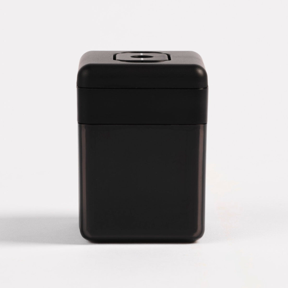 Front view of the Pendulum PMU pencil sharpener in matte black with a translucent base on a white background.