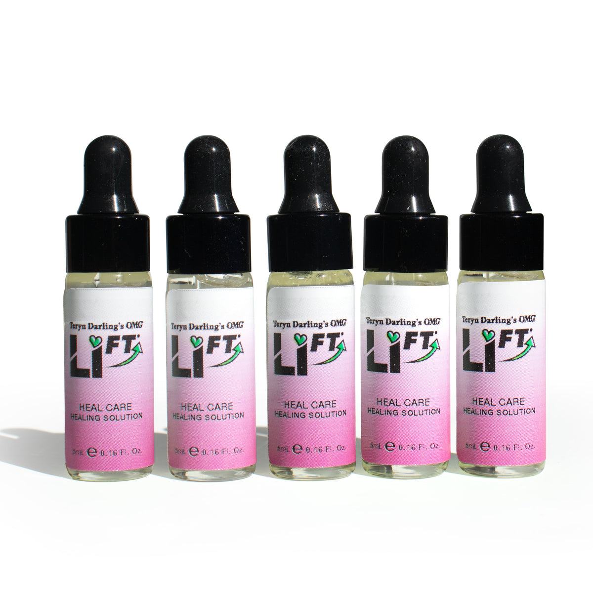 Five bottles of Teryn Darling’s OMG Li-FT Heal Care Healing Solution arranged in a row, a professional aftercare serum used to soothe and support skin healing following PMU lightening or saline removal treatments.
