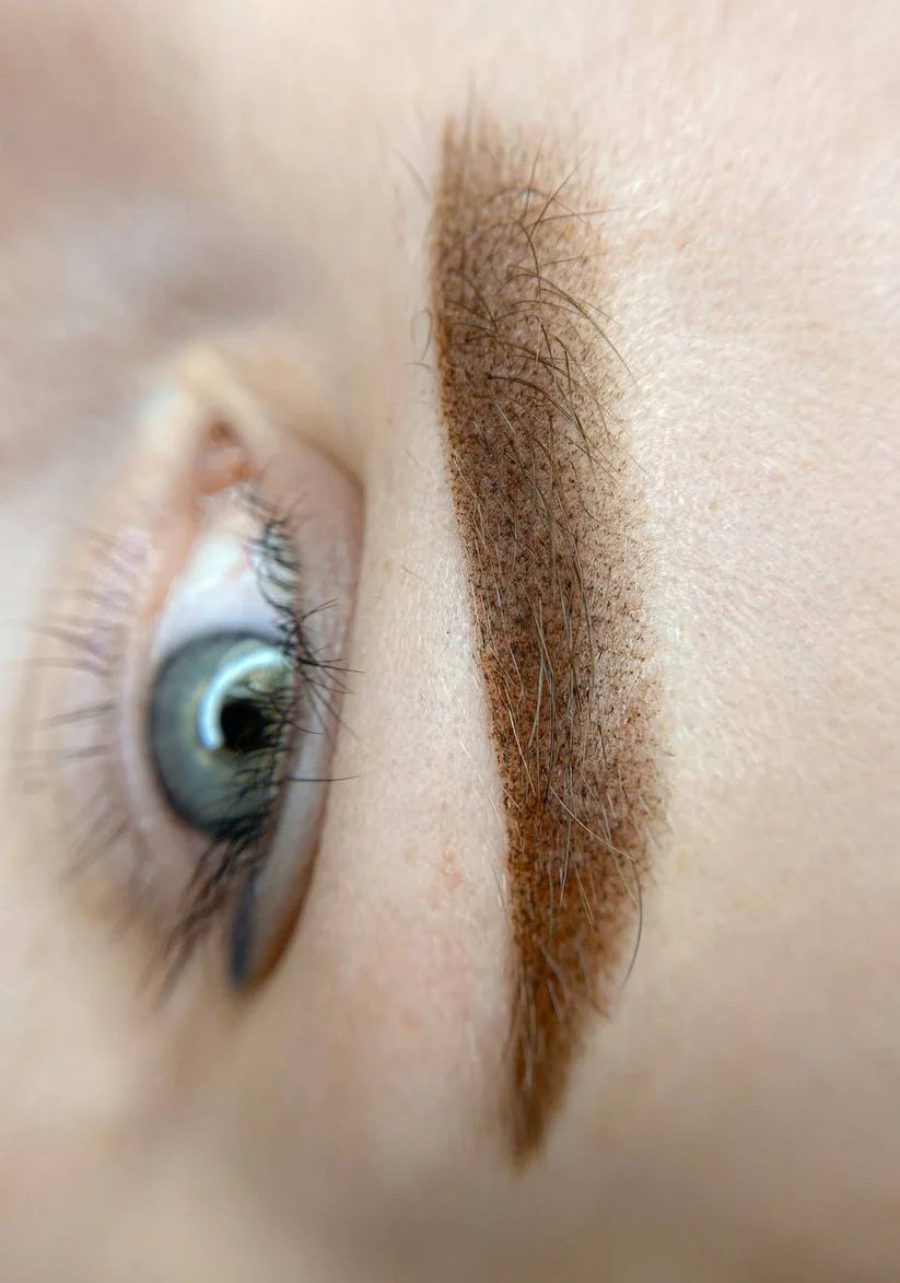 Close-up of a healed eyebrow tattoo using Hanafy Golden Blonde PMU pigment on fair skin.